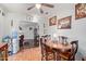 View of the dining room with hardwood floors and a ceiling fan, with art of vases hanging on the wall at 2315 N 12Th St, Phoenix, AZ 85006