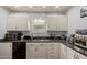Kitchen with granite countertops and white cabinets with modern appliances at 2315 N 12Th St, Phoenix, AZ 85006