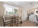 Bright laundry room with a washer and dryer and a small table with seating next to a window at 2315 N 12Th St, Phoenix, AZ 85006