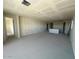 Spacious living room with smooth concrete floors and prepped walls featuring visible ductwork and natural light at 2447 E Spur Dr, San Tan Valley, AZ 85140