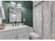 Bathroom featuring a modern vanity, decorative mirror, and tiled shower with patterned curtain at 248 S 95Th Pl, Chandler, AZ 85224