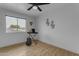Bedroom with wood-look floors, a large window, and musical instruments at 248 S 95Th Pl, Chandler, AZ 85224
