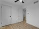 Bedroom with a neutral color scheme, wood-look floors, and ample closet space at 248 S 95Th Pl, Chandler, AZ 85224
