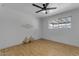 Bedroom with wood-look floors, neutral walls, a large window, and a ceiling fan at 248 S 95Th Pl, Chandler, AZ 85224