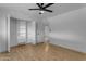 Bedroom featuring a ceiling fan, closet with built-in storage, and wood-look floors at 248 S 95Th Pl, Chandler, AZ 85224