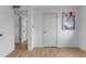 Hallway with wood-look floors, neutral walls, and two doors at 248 S 95Th Pl, Chandler, AZ 85224