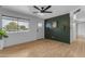 Spacious living room features modern wood paneling, a ceiling fan, and wood-look floors at 248 S 95Th Pl, Chandler, AZ 85224
