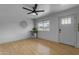 Empty living room with wood-look floors, a ceiling fan, and a white front door at 248 S 95Th Pl, Chandler, AZ 85224