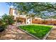 Landscaped backyard with green grass, patio, and beautiful tree at 26111 W Yukon Dr, Buckeye, AZ 85396