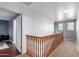 Bright hallway showcasing the wood banister and entry to the bedroom at 26111 W Yukon Dr, Buckeye, AZ 85396