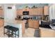 Well-lit kitchen featuring modern appliances, granite countertops, tile backsplash and center island with seating at 26111 W Yukon Dr, Buckeye, AZ 85396