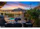 Charming backyard with a pool, outdoor dining area, and string lights, creating a perfect outdoor retreat at 2733 E Virginia St, Gilbert, AZ 85296