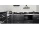 A bar featuring sleek dark wood cabinetry, countertops, and an under-counter refrigerator, creating a stylish space at 2733 E Virginia St, Gilbert, AZ 85296