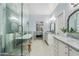 An expansive bathroom with dual sinks, a freestanding tub, and a glass shower with blue marble-look walls at 2733 E Virginia St, Gilbert, AZ 85296