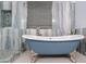 A detailed view of an elegant bathroom featuring a blue tub with ornate legs and decorative blue marbled walls at 2733 E Virginia St, Gilbert, AZ 85296