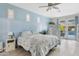 Serene bedroom with ensuite access to the backyard pool, light blue walls and stylish wood-look floors at 2733 E Virginia St, Gilbert, AZ 85296