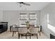A modern dining area with plank wall, dark wood table, fabric chairs, and a view of the backyard at 2733 E Virginia St, Gilbert, AZ 85296