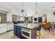 Spacious kitchen island with marble countertops open to the living and dining areas at 2733 E Virginia St, Gilbert, AZ 85296