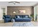 Comfortable living room features a stylish blue sofa and unique wood accent wall at 2733 E Virginia St, Gilbert, AZ 85296