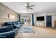 Spacious living room with blue sofa, wood accent wall, and access to the pool at 2733 E Virginia St, Gilbert, AZ 85296