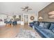 Bright living room with blue sofa, adjacent to the kitchen and dining area at 2733 E Virginia St, Gilbert, AZ 85296