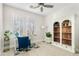 Bright office space with wood-look floors, shutters, and a decorative bookcase for storage and decor at 2733 E Virginia St, Gilbert, AZ 85296