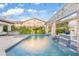 Sparkling swimming pool with decorative water features and lush landscaping in the backyard at 2733 E Virginia St, Gilbert, AZ 85296
