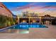 Expansive backyard pool area with water features and elegant tile work, creating a luxurious outdoor oasis at 2733 E Virginia St, Gilbert, AZ 85296
