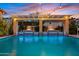 Resort-style pool with waterfall features, ambient lighting, and lush greenery, perfect for relaxation at 2733 E Virginia St, Gilbert, AZ 85296
