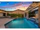 Beautiful backyard pool area illuminated by string lights at dusk, perfect for evening relaxation and entertainment at 2733 E Virginia St, Gilbert, AZ 85296