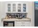 Stylish wet bar area with frosted glass cabinets and marble countertops at 2733 E Virginia St, Gilbert, AZ 85296