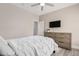 Bedroom featuring a comfortable bed with white linens, a ceiling fan, and a dresser with a television at 30427 W Vale Dr, Buckeye, AZ 85396