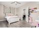 Bright bedroom with ceiling fan featuring a bed, desk, and doorway at 30427 W Vale Dr, Buckeye, AZ 85396