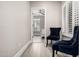 Sitting area with chairs that offers a glimpse into the bedroom with bright windows at 30427 W Vale Dr, Buckeye, AZ 85396