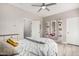 Bedroom with ceiling fan featuring a bed, desk, and doorway at 30427 W Vale Dr, Buckeye, AZ 85396