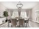 Dining room showcasing neutral walls, curtains, plantation shutters, and wood-look flooring at 30427 W Vale Dr, Buckeye, AZ 85396