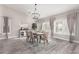 Formal dining room with chandelier, neutral walls, plantation shutters, and wood-look floors at 30427 W Vale Dr, Buckeye, AZ 85396