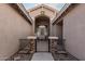 Inviting entryway with stone pillars, iron gate, and neutral decor, creating a warm welcome at 30427 W Vale Dr, Buckeye, AZ 85396