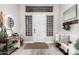 Bright foyer with a rustic rug, decorative furniture, and glass block windows, creating an inviting atmosphere at 30427 W Vale Dr, Buckeye, AZ 85396