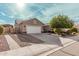 Attractive home with a two-car garage, concrete driveway, and low-maintenance gravel landscaping at 30427 W Vale Dr, Buckeye, AZ 85396
