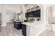 Bright open-concept kitchen with black cabinets, white countertops, and stainless steel appliances at 30427 W Vale Dr, Buckeye, AZ 85396