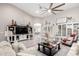 Open-concept living room with stylish decor, large television, and comfortable seating, perfect for Gathering gatherings at 30427 W Vale Dr, Buckeye, AZ 85396