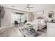 Spacious main bedroom featuring a ceiling fan, bay window, and decor at 30427 W Vale Dr, Buckeye, AZ 85396