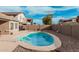Backyard pool with desert landscaping, block fencing, and inviting lounge area at 30427 W Vale Dr, Buckeye, AZ 85396
