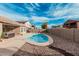 Backyard pool with desert landscaping, block fencing, and inviting lounge area at 30427 W Vale Dr, Buckeye, AZ 85396