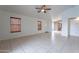 Open living room with tile flooring, ceiling fan, and natural light from two window at 4032 E Arbor Ave, Mesa, AZ 85206