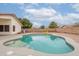 Backyard view of a kidney-shaped pool with orange gravel landscaping and a yellow football uprights at 4032 E Arbor Ave, Mesa, AZ 85206