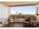 Relaxing balcony with comfortable seating and views of the tropical palm trees and sunny skies at 4141 N 31St St # 405, Phoenix, AZ 85016