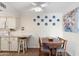 Cozy kitchen dining area with white cabinets and barstool seating at 4141 N 31St St # 405, Phoenix, AZ 85016