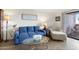 Cozy living room with plush blue sofa, glass coffee table, and neutral accents at 4141 N 31St St # 405, Phoenix, AZ 85016